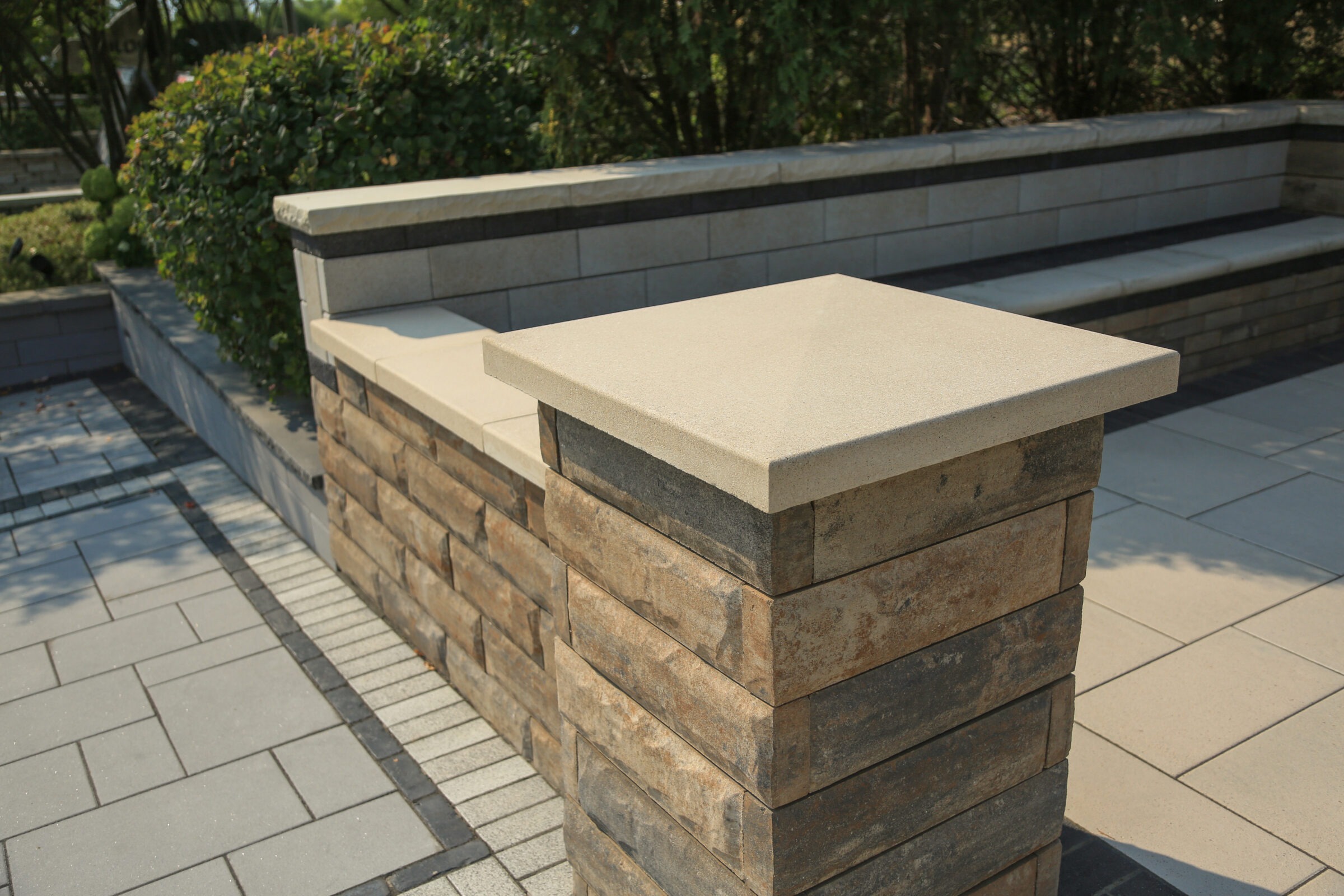 Stone pillar with brick-patterned wall