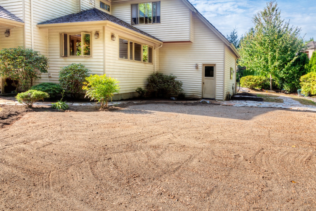 Backyard with landscaping and white house exterior