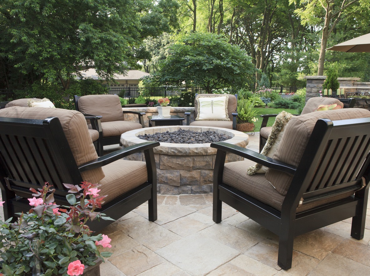 Outdoor patio with chairs and fire pit.