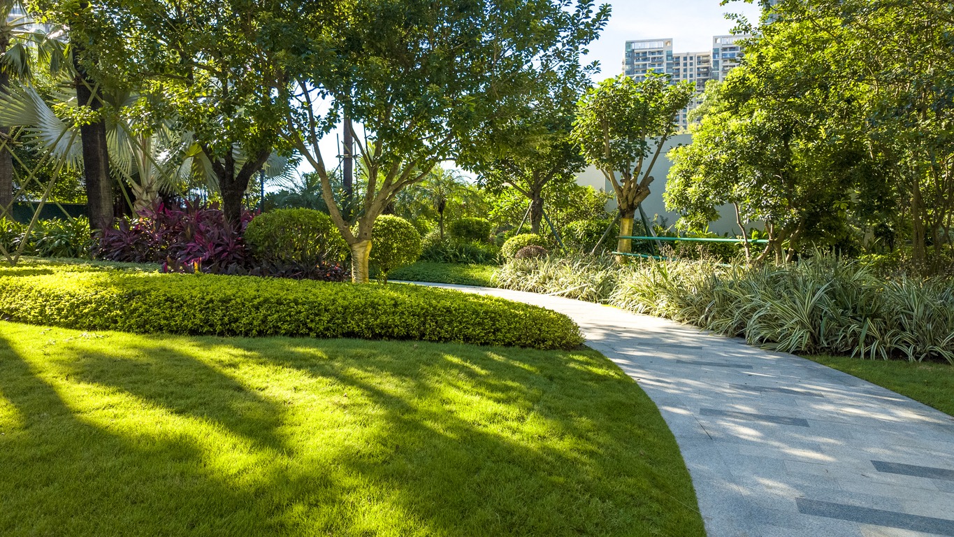 Lush garden with winding stone pathway.