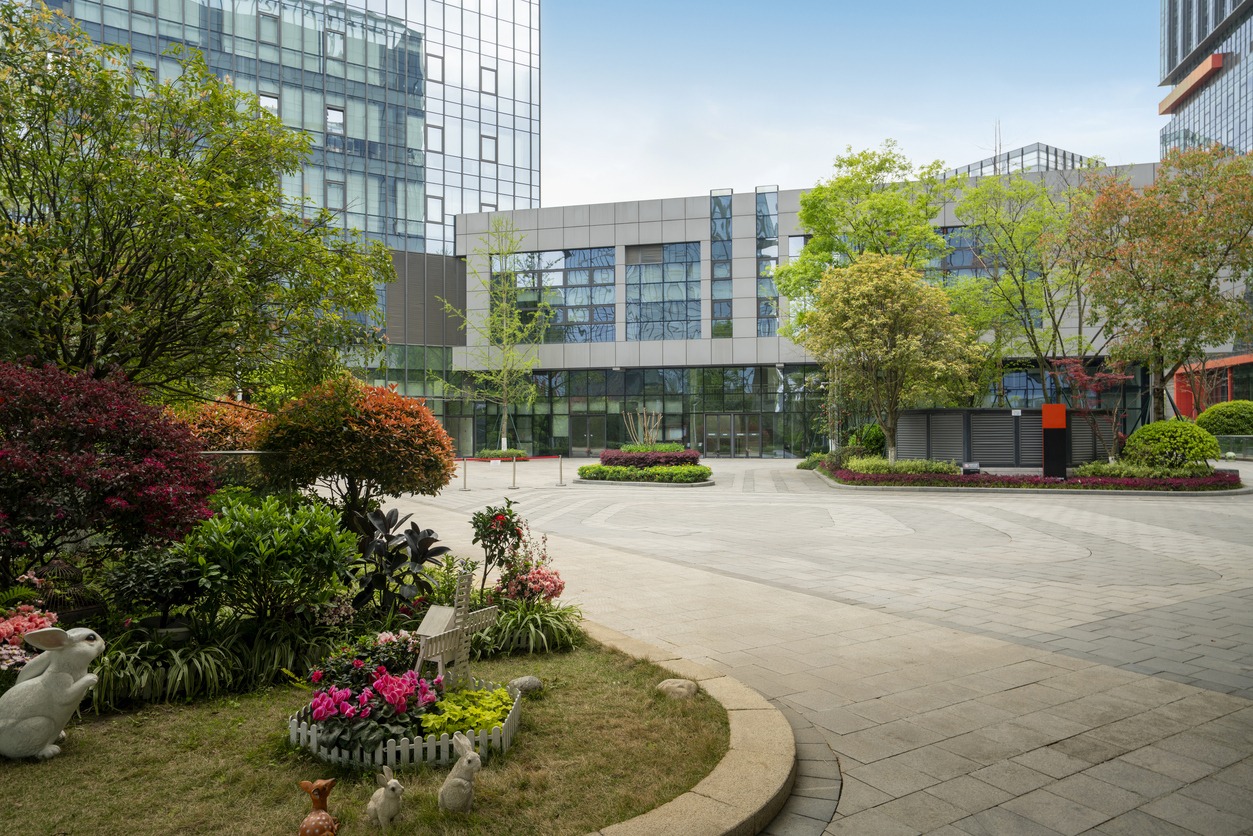 Modern building exterior with landscaped garden view.