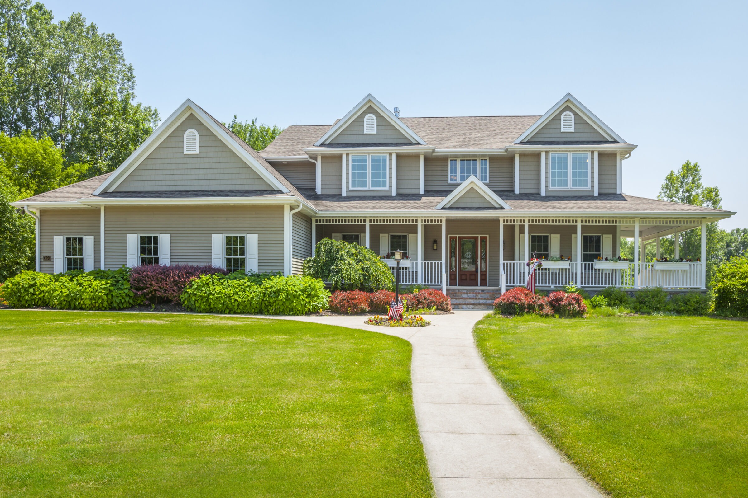 Beautiful suburban house with front porch and garden.