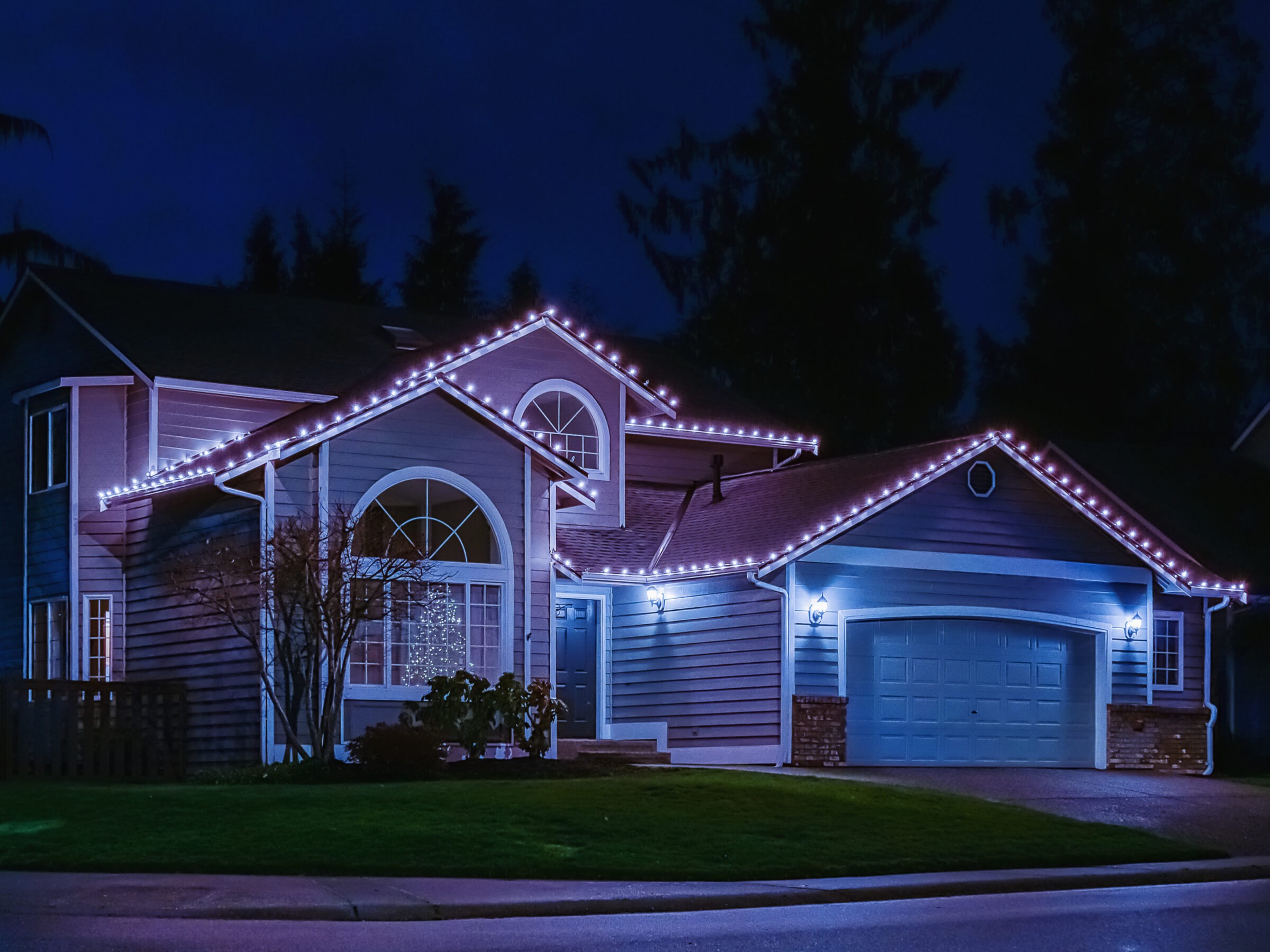 House with Christmas lights at night.