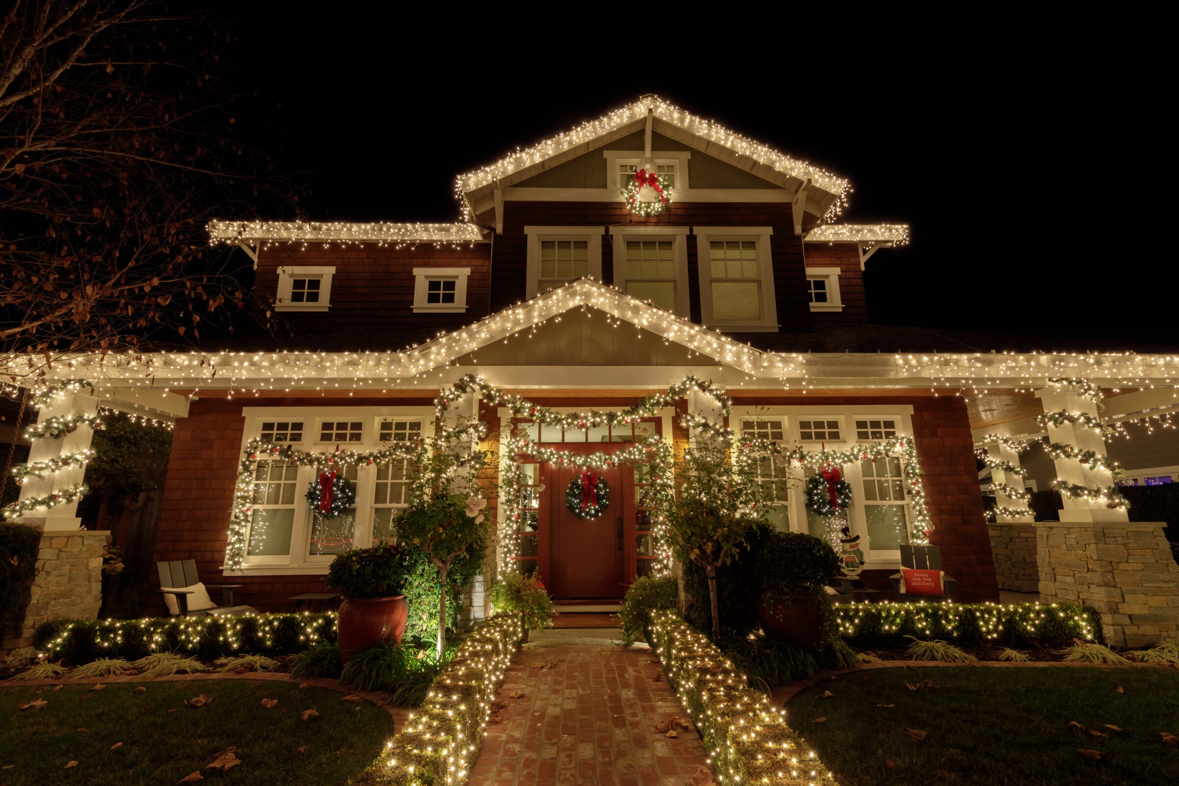House decorated with Christmas lights at night.