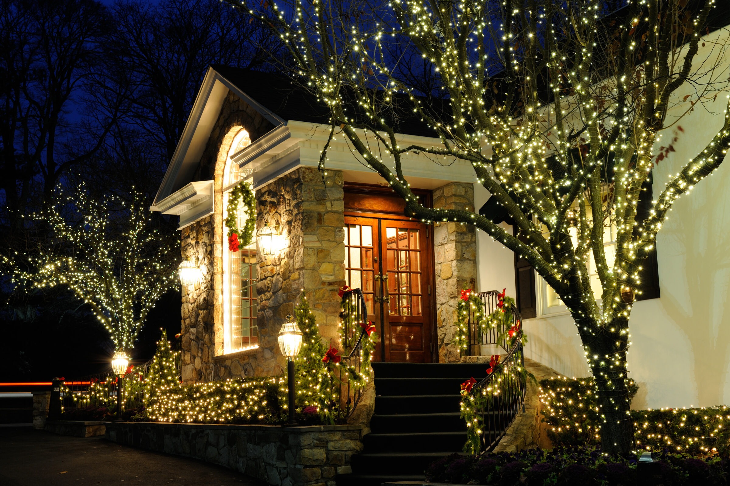 House decorated with Christmas lights and wreaths