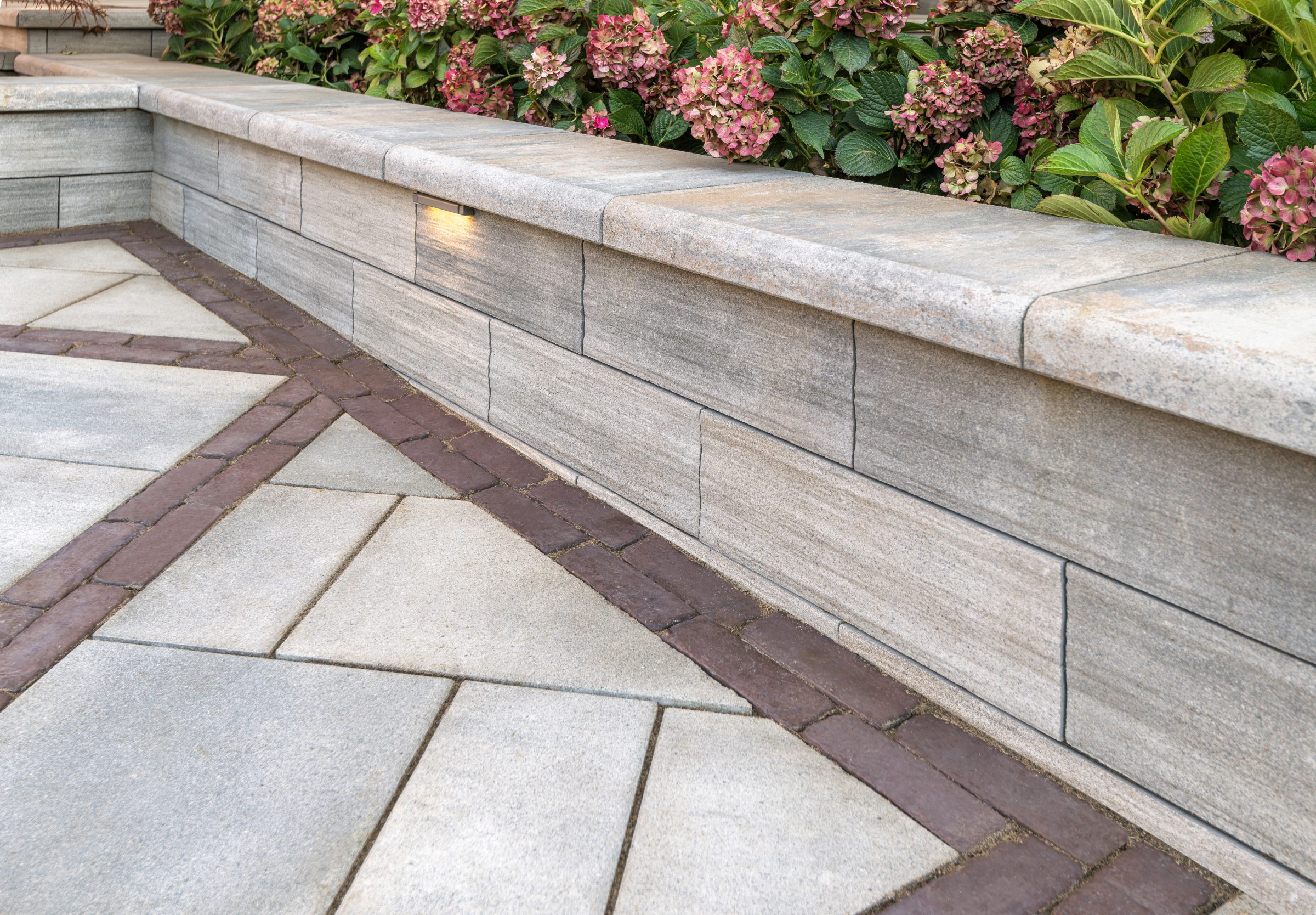 Stone patio with decorative flower border