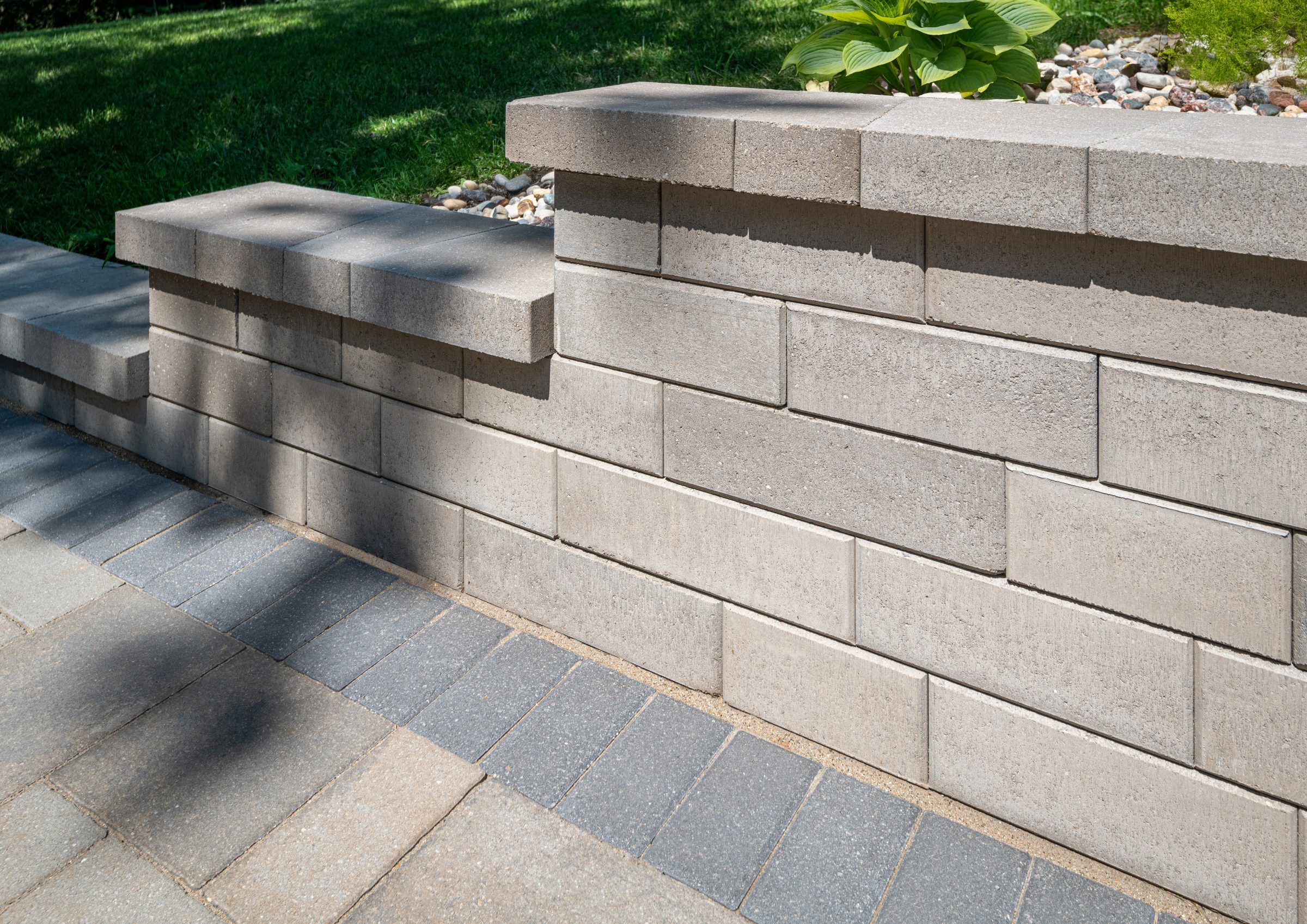 Brick retaining wall in a landscaped garden.