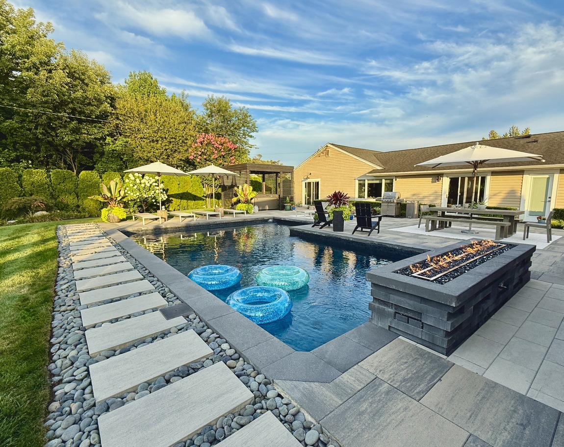 Modern backyard with pool and fire pit.
