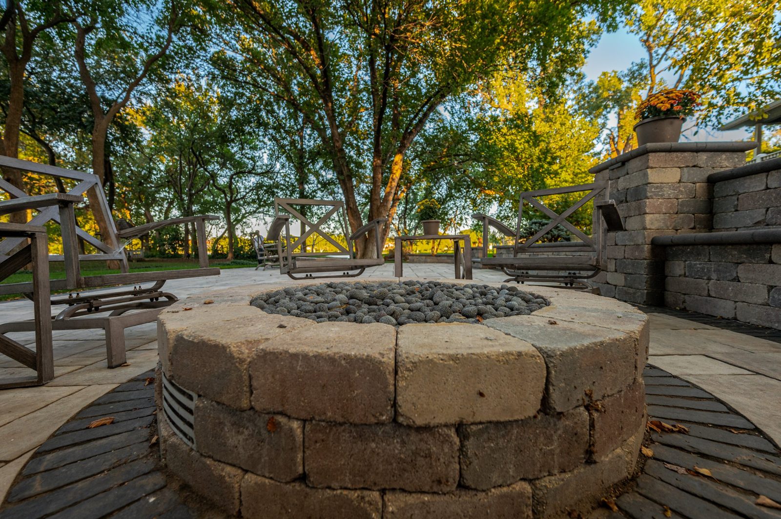 Paver patio with circular fire pit and seating in Wichita, KS